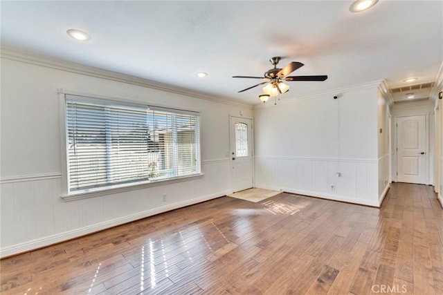 spare room with ornamental molding, hardwood / wood-style floors, and ceiling fan