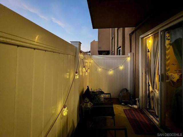 view of balcony at dusk