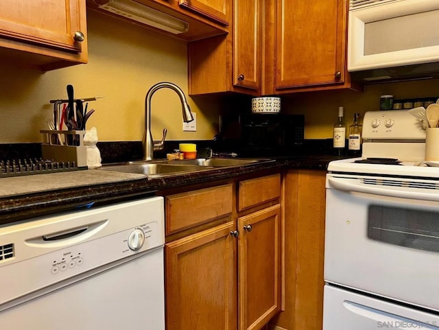 kitchen featuring sink and white appliances