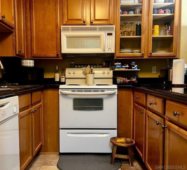 kitchen with light tile patterned flooring and white appliances