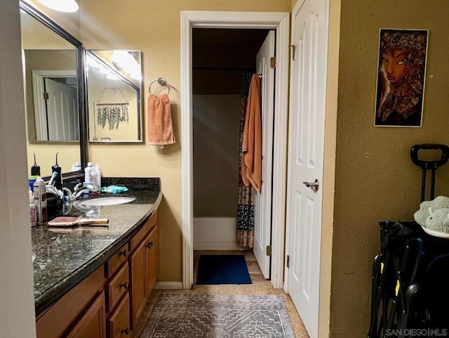 bathroom with vanity, shower / tub combo with curtain, and tile patterned floors