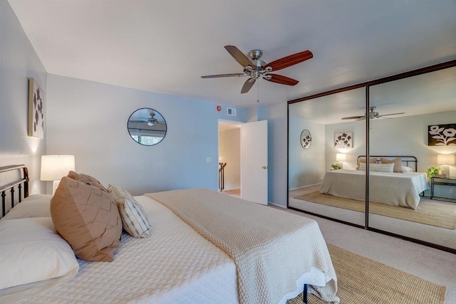 bedroom with a closet, ceiling fan, and carpet