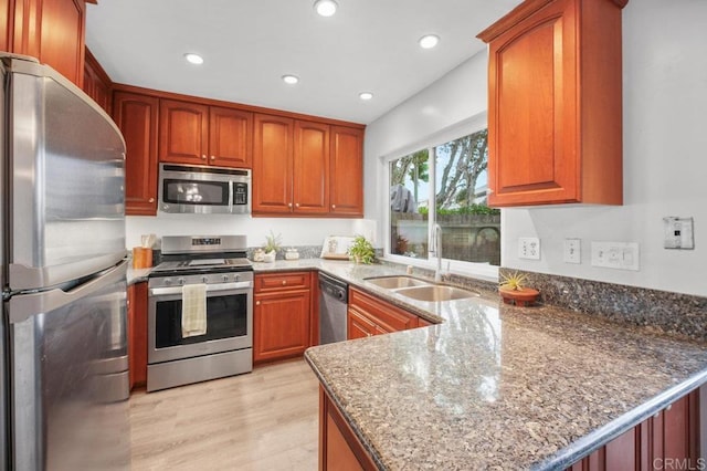 3575 Monair Dr Unit C, San Diego, CA 92117 - kitchen with stainless steel appliances, a sink, a peninsula, dark stone counters, and recessed lighting
