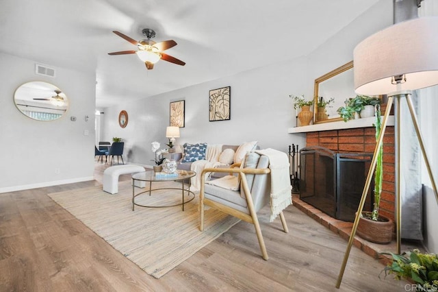 3575 Monair Dr Unit C, San Diego, CA 92117 - living area with a ceiling fan, a fireplace, wood finished floors, and baseboards