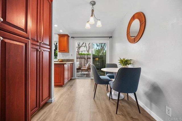 3575 Monair Dr Unit C, San Diego, CA 92117 - dining room featuring light wood-type flooring, a chandelier, and baseboards
