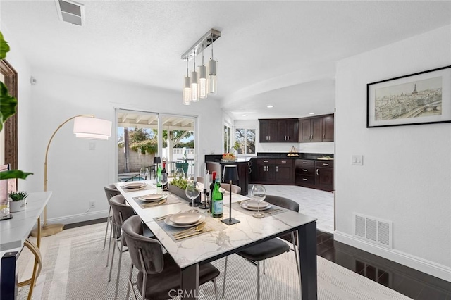 dining space with hardwood / wood-style floors