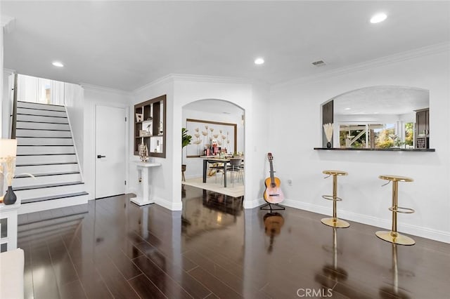 interior space with crown molding and dark wood-type flooring