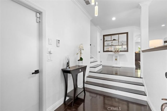 stairs with crown molding and wood-type flooring