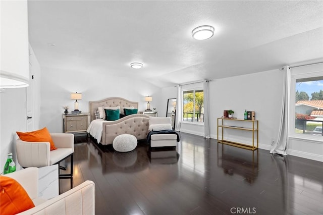 bedroom with vaulted ceiling and dark hardwood / wood-style floors