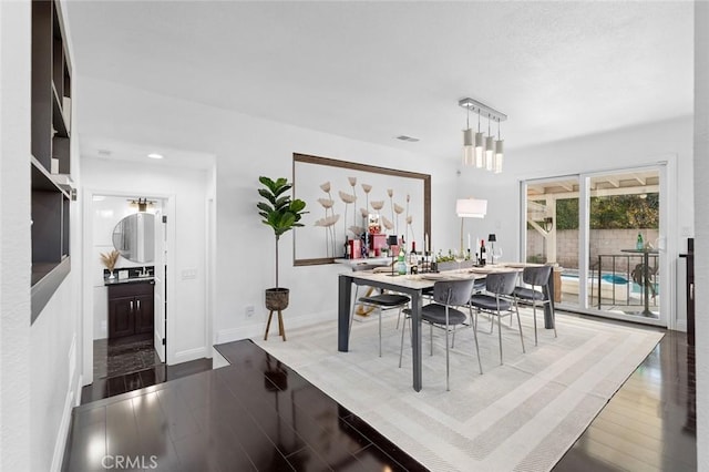 dining space with dark hardwood / wood-style floors