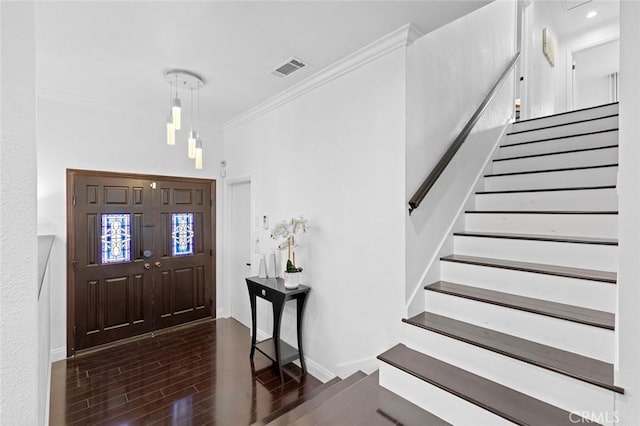 foyer entrance featuring crown molding