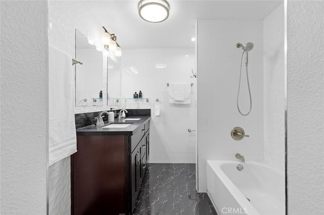 bathroom with tiled shower / bath combo and vanity