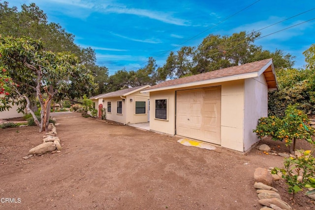 exterior space with a garage and an outdoor structure