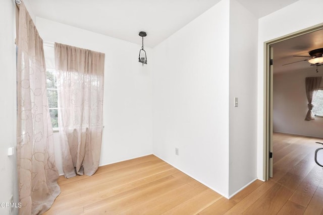 unfurnished dining area featuring ceiling fan, hardwood / wood-style floors, and a wealth of natural light