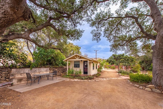 view of yard with an outbuilding and a patio area