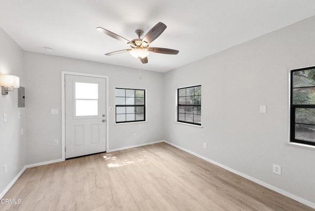 entryway featuring ceiling fan, electric panel, and light wood-type flooring