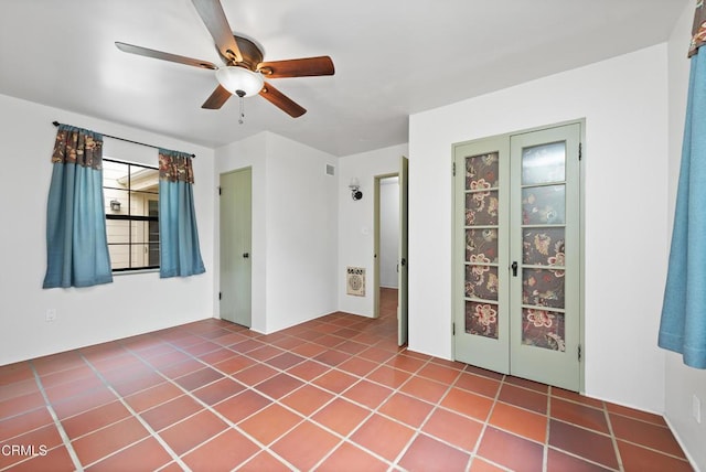 unfurnished room featuring tile patterned floors and ceiling fan