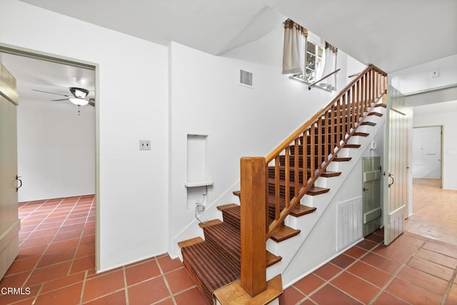 stairway featuring tile patterned flooring and ceiling fan