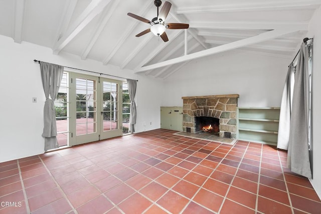 unfurnished living room with beamed ceiling, a stone fireplace, tile patterned floors, and ceiling fan