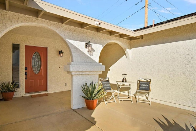 doorway to property with a patio area