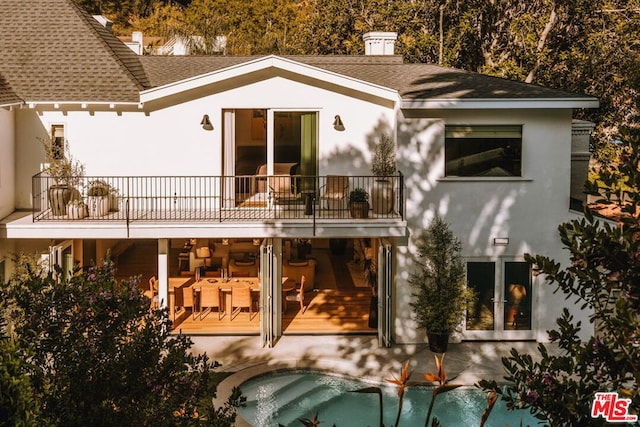 back of property with a balcony