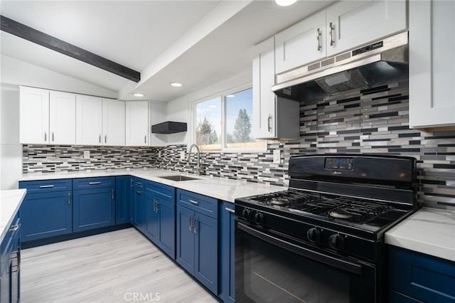 kitchen with blue cabinets, lofted ceiling, sink, white cabinets, and gas stove