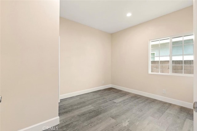 spare room with hardwood / wood-style flooring