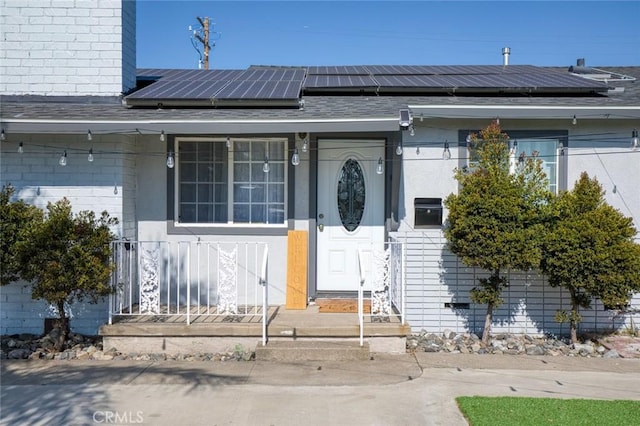 doorway to property featuring solar panels