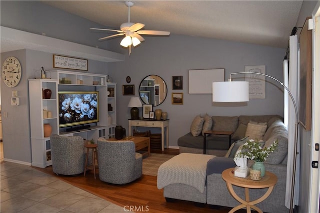 living room with hardwood / wood-style floors, vaulted ceiling, and ceiling fan