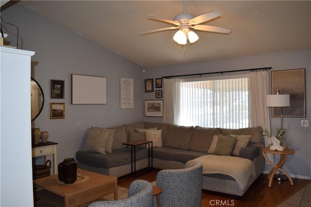 living room featuring vaulted ceiling, ceiling fan, and wood-type flooring