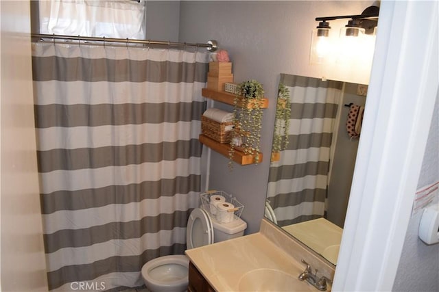 bathroom featuring vanity and toilet