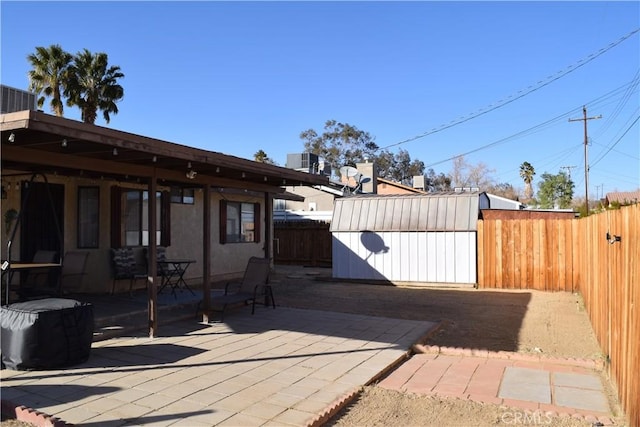 view of patio / terrace with a storage shed