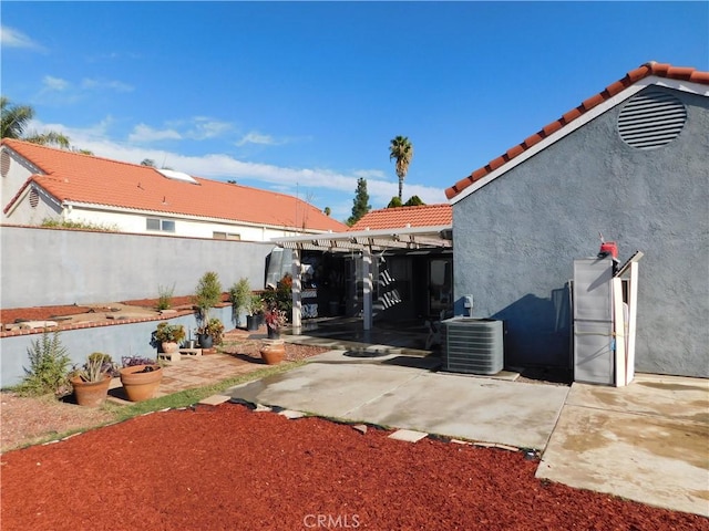 view of yard featuring central AC and a patio