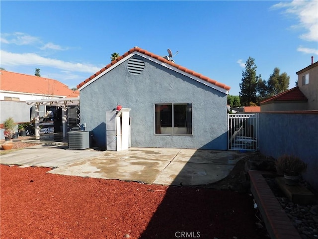 back of property featuring cooling unit and a patio area