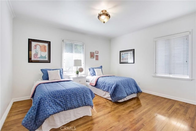 bedroom with hardwood / wood-style flooring and ornamental molding