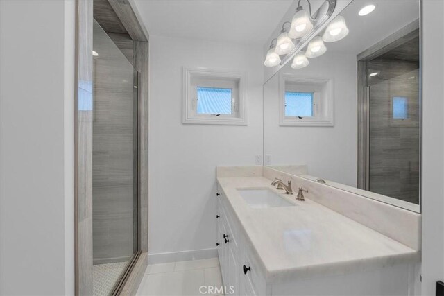 bathroom featuring vanity, a shower with shower door, and tile patterned floors