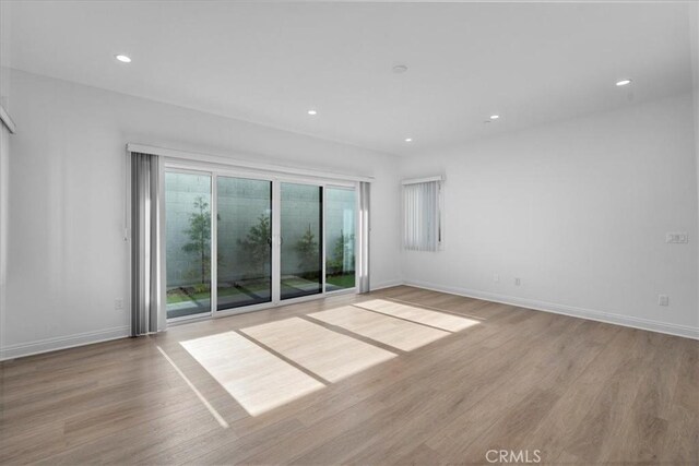 empty room with light hardwood / wood-style flooring