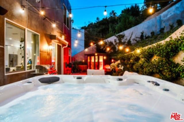 snow covered patio featuring a hot tub