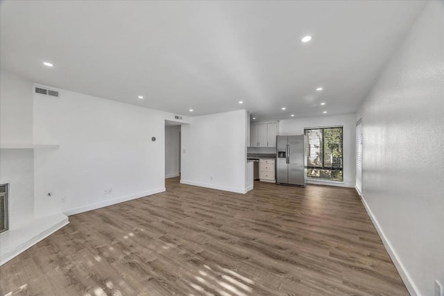 unfurnished living room with wood-type flooring