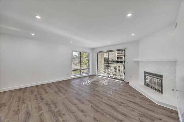 unfurnished living room with a fireplace and light hardwood / wood-style floors