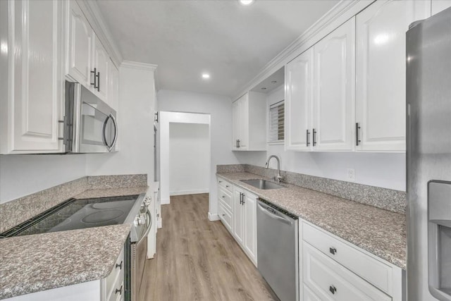 kitchen with white cabinetry, sink, light hardwood / wood-style flooring, and stainless steel appliances