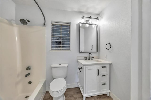 full bathroom with hardwood / wood-style flooring, vanity, toilet, and shower / bath combination