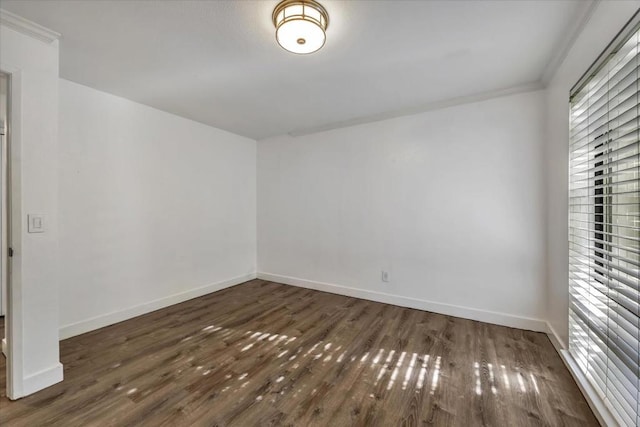 unfurnished room with dark hardwood / wood-style flooring