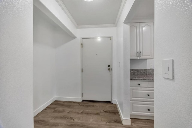 interior space featuring crown molding and light hardwood / wood-style floors