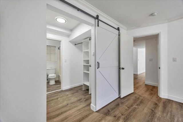 interior space featuring a barn door and hardwood / wood-style floors