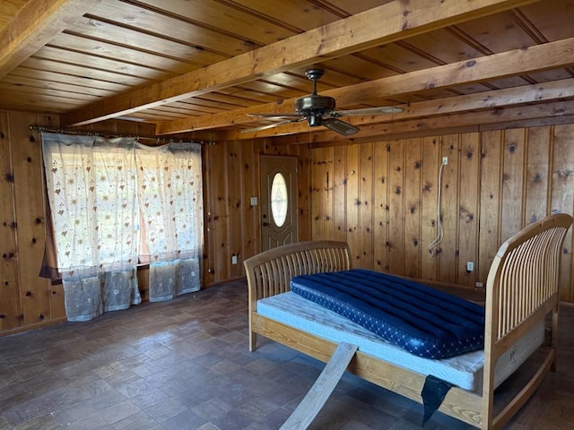 bedroom featuring beamed ceiling, wooden ceiling, and wood walls