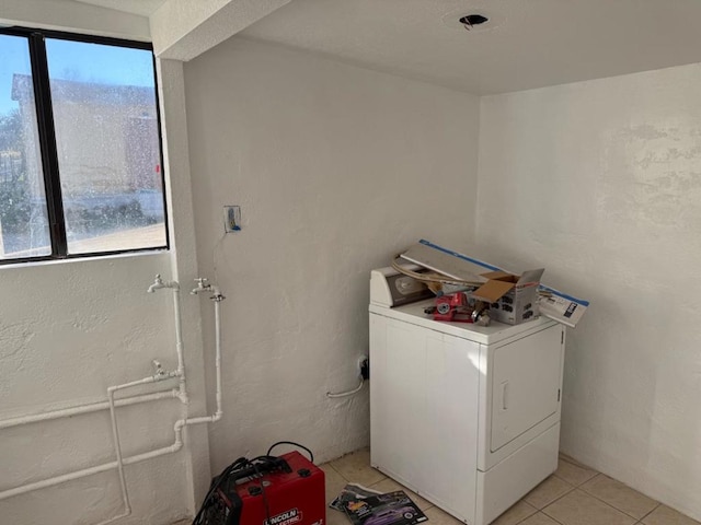 clothes washing area with light tile patterned flooring and washer / dryer