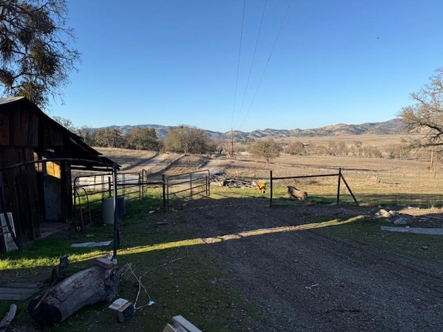 view of yard featuring a mountain view and a rural view