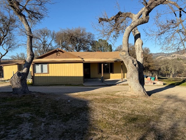 exterior space featuring a patio, a mountain view, and a lawn