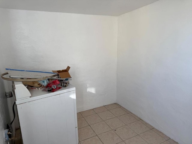 laundry area featuring washer / dryer and light tile patterned floors